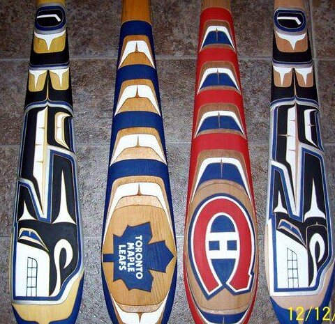 Custom NHL team paddles carved by Ross Henderson