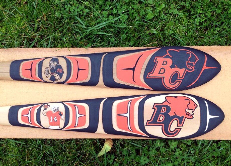 Custom BC Lions paddles carved by Ross Henderson