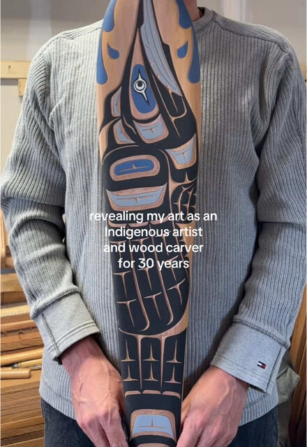 Ross Henderson with a carved formline paddle